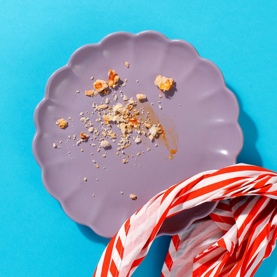 An empty plate with only some crumbs left on it - ur delicious Caramelised Peach and Coconut Tarts are irresistible.