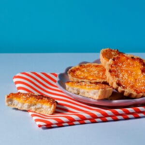 Caramelised Peach and Coconut Tarts on a plate - from our range of cakes and tarts for coffee shops.