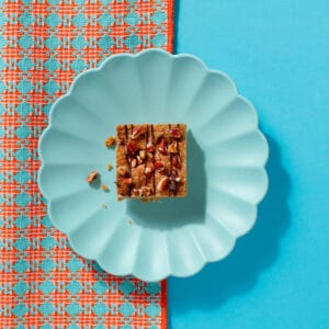 Top-down view of Maple and Pecan Flapjack showing golden oat texture and scattered pecans.