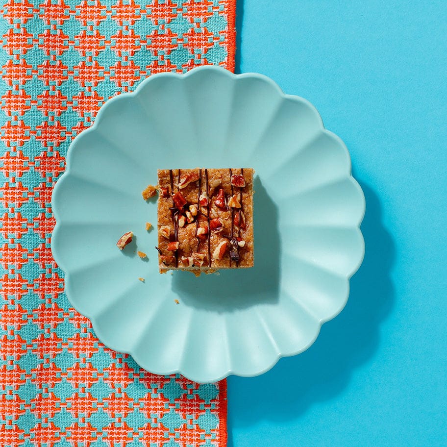 Top-down view of Maple and Pecan Flapjack showing golden oat texture and scattered pecans.