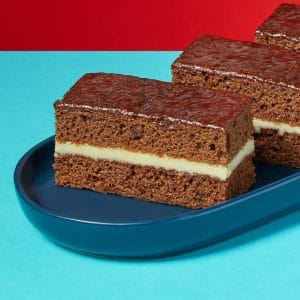 Rum and Ginger Traycake slices neatly arranged with visible cream cheese filling.