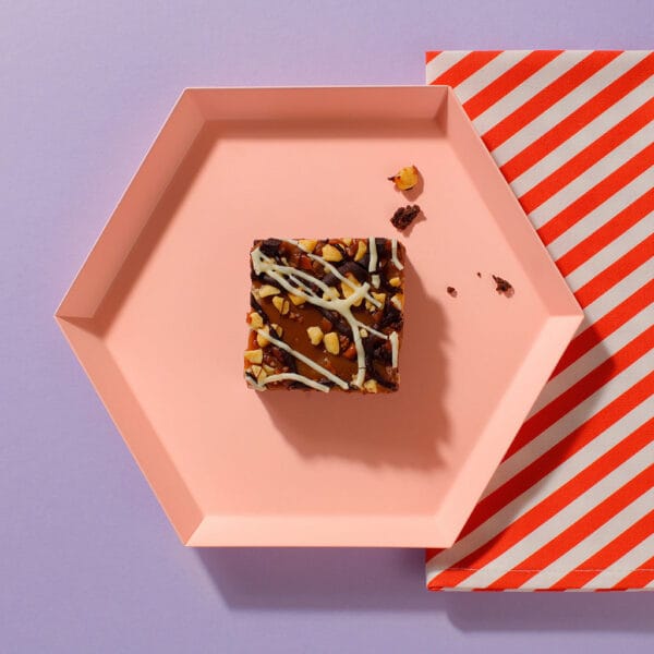 An overhead view of one of our Salted Caramel And Comb Brownies on an hexagonal plate.