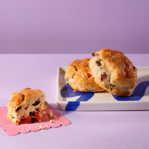 The Big Sultana scones on a lilac backdrop – golden, buttery café classic from Cake Club.
