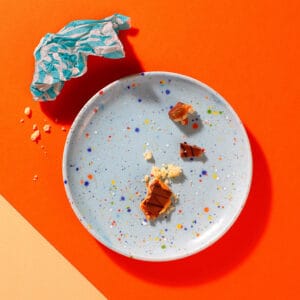 Empty plate with crumbs from The Millionaire shortbread traybake – buttery shortcake and caramel layers.