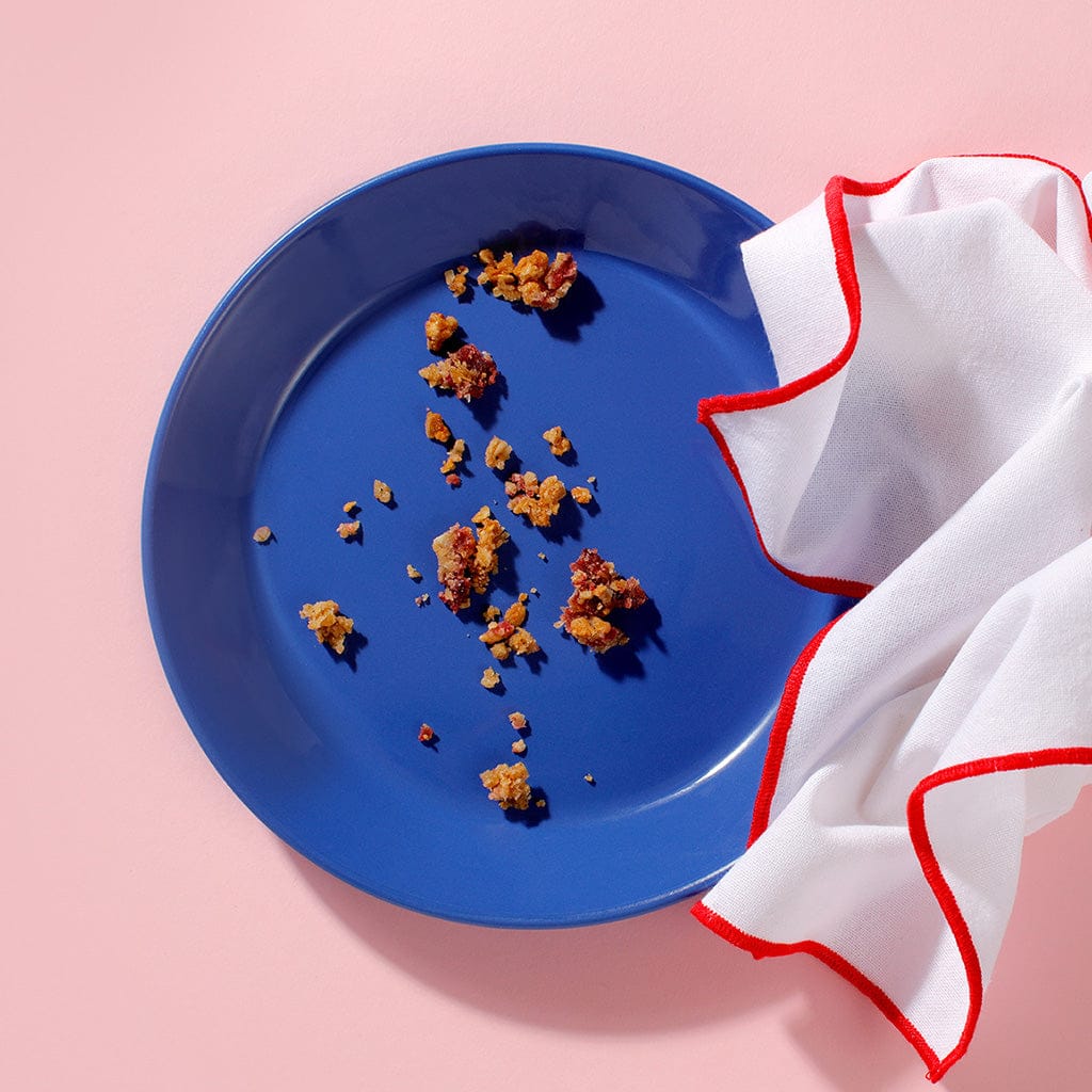 Vegan Berry Crumble crumbs on blue plate after serving – Cake Club vegan dessert for cafés.