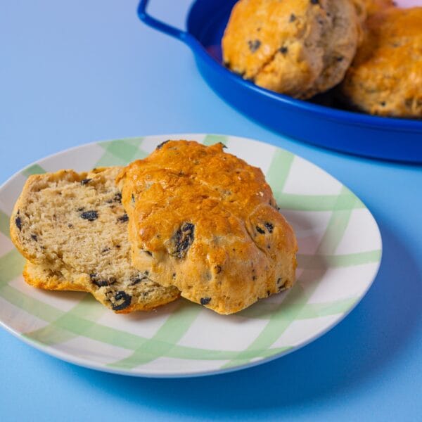 Black Olive Scone on a plate with black olive pieces, Cake Club savoury bake.